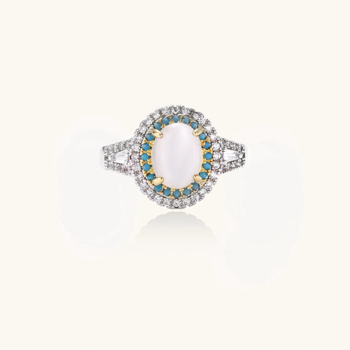 Vintage-style cocktail ring with luminous cat's eye center stone surrounded by turquoise and crystal double halo on white gold plated band