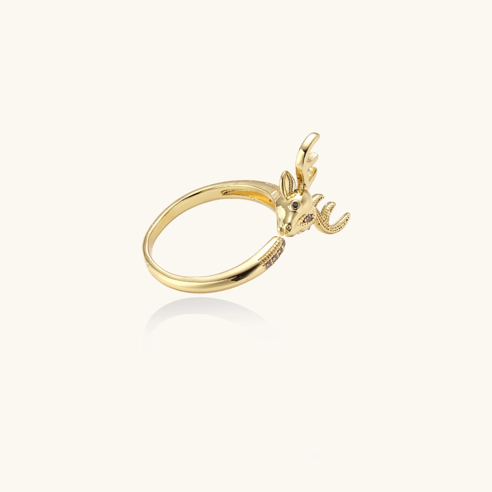 Gold-plated adjustable ring featuring 3D deer head with detailed antlers and cubic zirconia accents on cream background